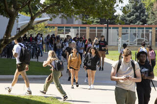 Additional Resources - a large group of students walking around campus